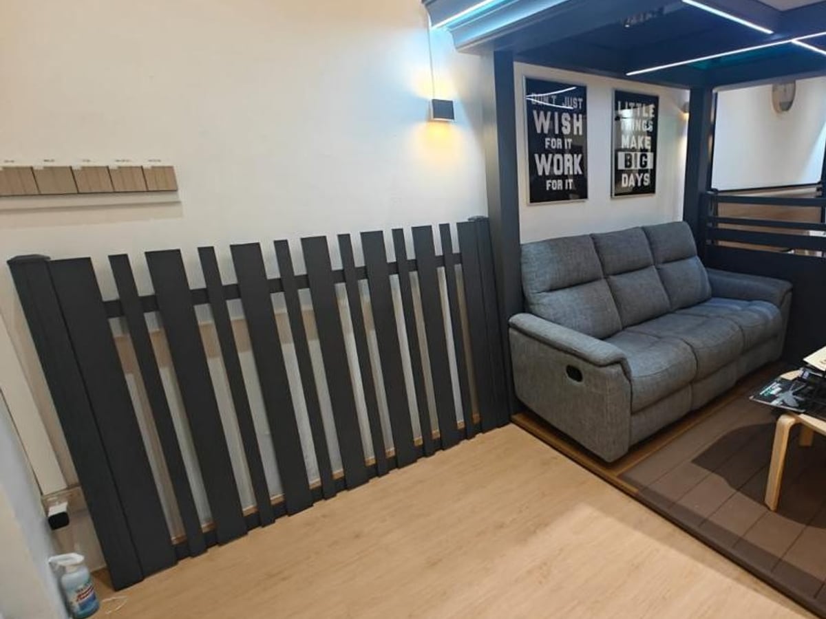 Dark aluminium slat fencing and screening beside a seating area
