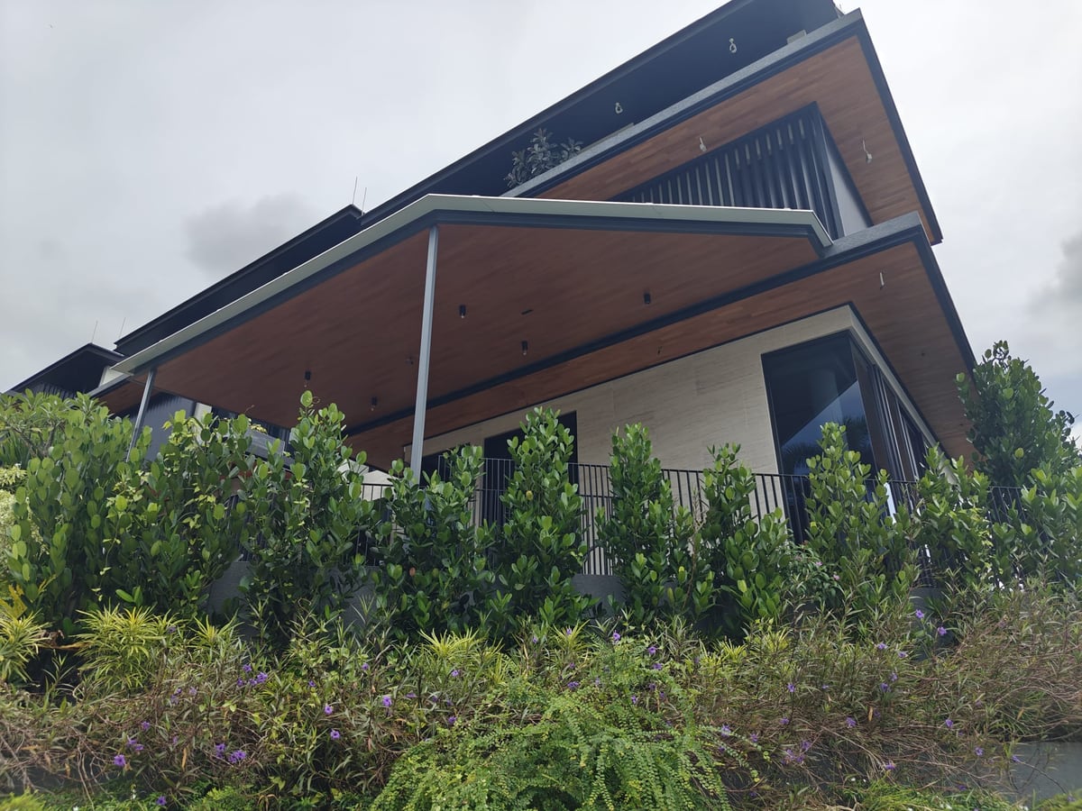 Aluminium smart roof structure on a residential building surrounded by greenery