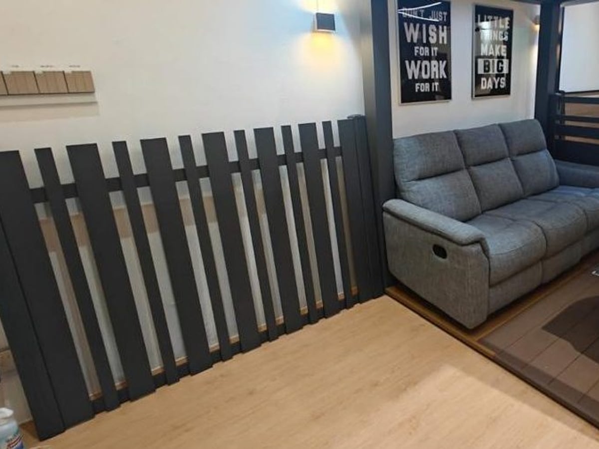 Dark aluminium slat fencing beside an indoor seating area